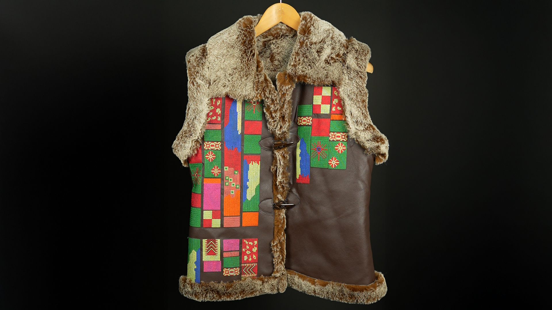 Fur-lined leather vest with multicolor embroidered geometric patterns